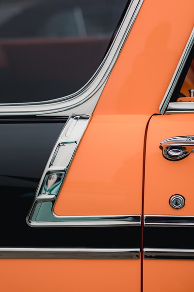 The orange and silver car in the parking lot
